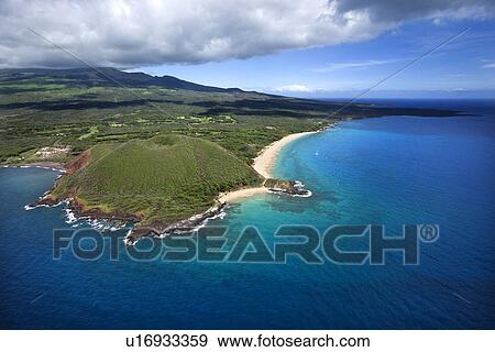 Stock Photo - Aerial of Maui, Hawaii coastline with crater and cliffs and beach on Pacific ocean. Fotosearch