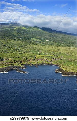 Stock Photo - Aerial of Maui, Hawaii coastline with mountains in background.. Fotosearch