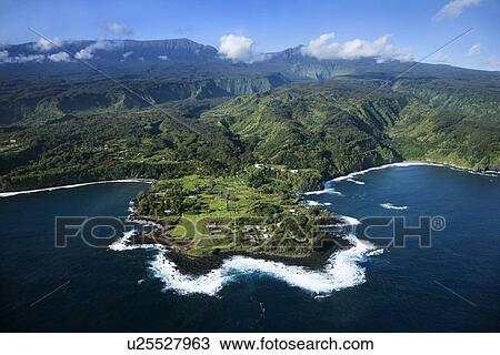 Aerial of rocky coast on Pacific ocean with mountains in background in Maui, Hawaii. View Large Photo Image Stock Image - Aerial of rocky coast on Pacific ocean with mountains in background in Maui, Hawaii.. Fotosearch
