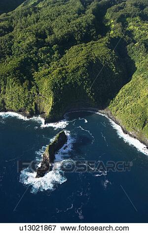 Stock Photo - Aerial view of Maui, Hawaii coast with rock jutting out of Pacific ocean. Fotosearch