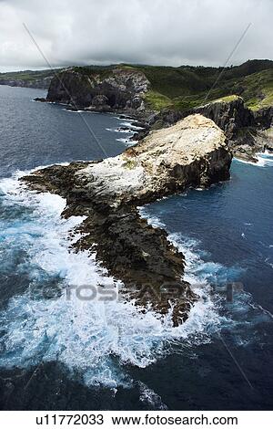 Stock Image - Aerial view of rocky cliffs on coastline of Maui, Hawaii.. Fotosearch