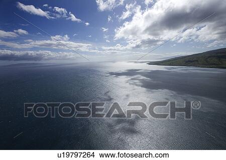 Picture - Pacific ocean and sky with clouds and corner of island in Hawaii. Fotosearch