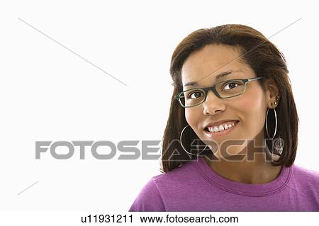 Stock Image - African American mid adult woman wearing glasses smiling at viewer.. Fotosearch