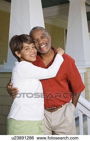 African American middle aged couple hugging and smiling at viewer. View Large Photo Image Stock Photograph - African American middle aged couple hugging and smiling at viewer.. Fotosearch