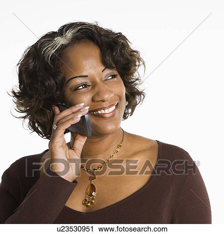 Portrait of woman holding telephone to ear and smiling. View Large Photo Image Stock Image - Portrait of woman holding telephone to ear and smiling.. Fotosearch
