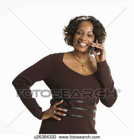 Portrait of woman holding telephone to ear and smiling. View Large Photo Image Stock Image - Portrait of woman holding telephone to ear and smiling.. Fotosearch