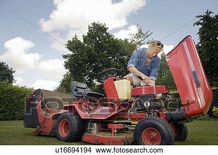 Man fixing lawn mower View Large Photo Image Picture - Man fixing lawn mower. Fotosearch