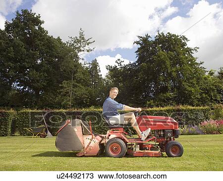 Man mowing a lawn View Large Photo Image Stock Image - Man mowing a lawn. Fotosearch