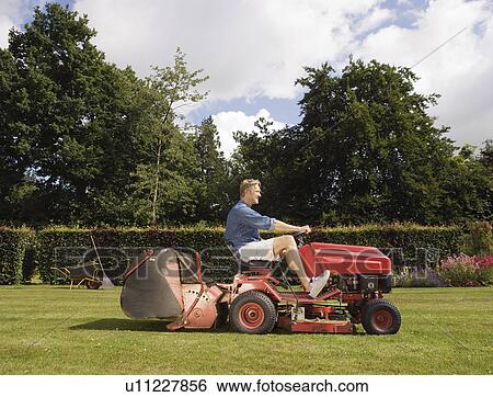 Stock Photograph - Man mowing a lawn. Fotosearch