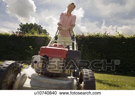 Man with push lawnmower, low angle View Large Photo Image Stock Image - Man with push lawnmower, low angle. Fotosearch