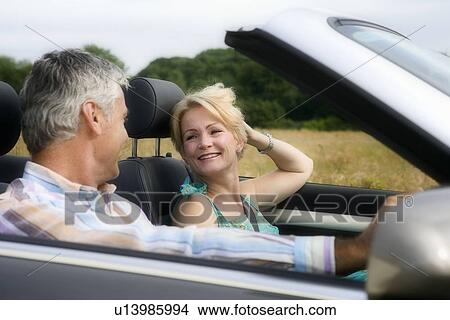 Middle age couple in convertible car View Large Photo Image Picture - Middle age couple in convertible car. Fotosearch