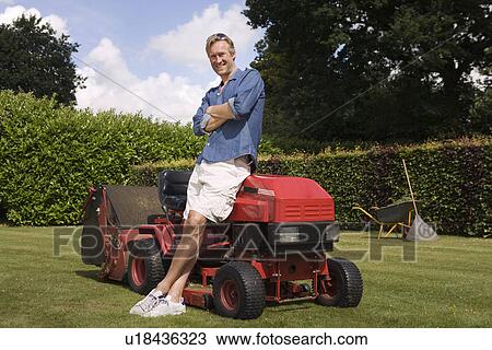 Portrait man standing by lawn mower View Large Photo Image Stock Image - Portrait man standing by lawn mower. Fotosearch