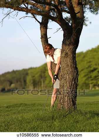 Woman hitting golf ball View Large Photo Image Stock Photography - Woman hitting golf ball. Fotosearch