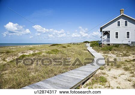 Beachfront house with wooden walkway View Large Photo Image Stock Photo - Beachfront house with wooden walkway. Fotosearch