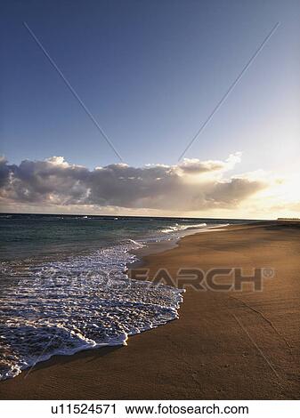 Stock Image - The beach at dusk in Maui, Hawaii. Fotosearch