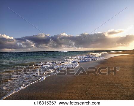 Waves lapping on the beach at dusk View Large Photo Image Stock Photo - Waves lapping on the beach at dusk. Fotosearch