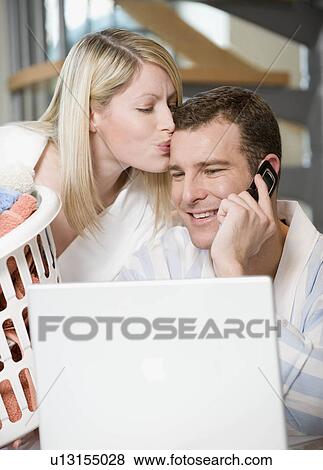 Stock Photo - A couple working at home. Fotosearch