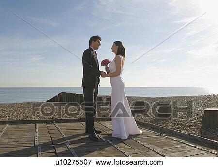 A wedding couple on the beach View Large Photo Image Stock Photo - A wedding couple on the beach. Fotosearch