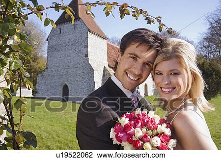 A wedding couple outside a chapel View Large Photo Image Stock Image - A wedding couple outside a chapel. Fotosearch