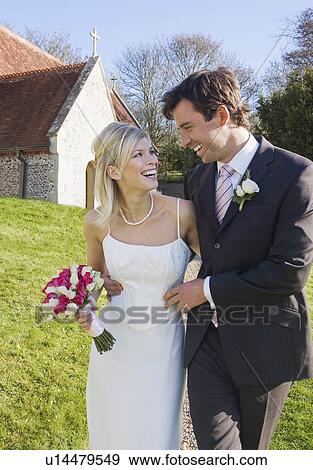 A wedding couple outside a chapel View Large Photo Image Stock Photo - A wedding couple outside a chapel. Fotosearch