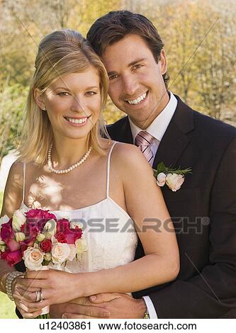 Stock Image - A wedding couple smiling to camera. Fotosearch