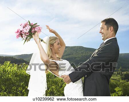 Stock Image - Bride and groom celebrating. Fotosearch