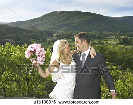 Stock Photograph - Bride and groom celebrating. Fotosearch