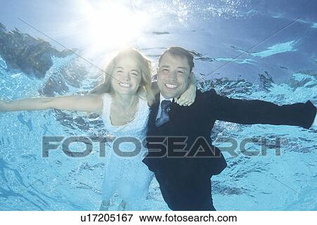 Stock Photo - Bride and groom underwater. Fotosearch