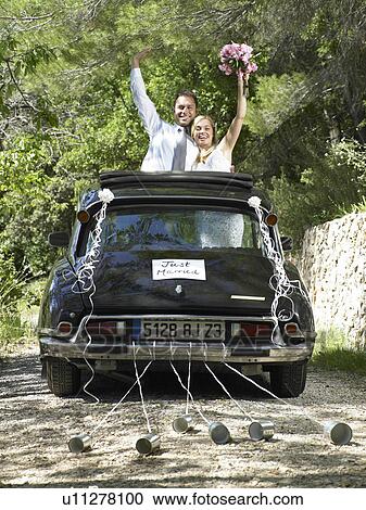 Bride and groom waving from wedding car View Large Photo Image Stock Image - Bride and groom waving from wedding car. Fotosearch