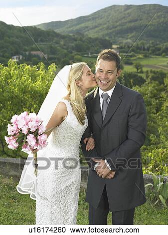 Bride kissing groom View Large Photo Image Stock Image - Bride kissing groom. Fotosearch