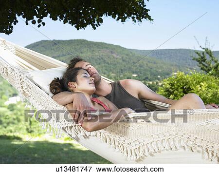 Stock Photo - Couple asleep on hammock. Fotosearch