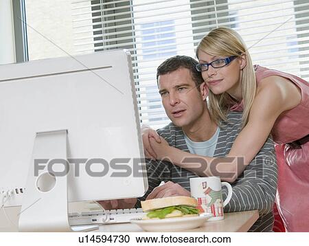 Stock Image - Couple working from home. Fotosearch