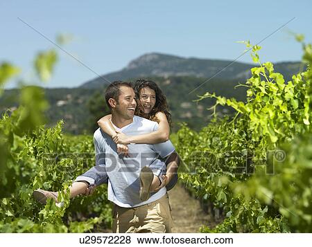 Man carrying woman on vacation View Large Photo Image Stock Photo - Man carrying woman on vacation. Fotosearch