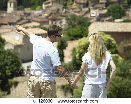 Rear of couple looking at view View Large Photo Image Stock Image - Rear of couple looking at view. Fotosearch