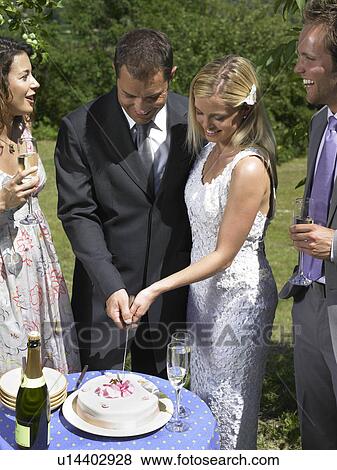 Wedding couple cutting cake View Large Photo Image Stock Photo - Wedding couple cutting cake. Fotosearch