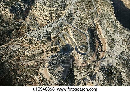 Stock Photo - Aerial of curvy road in high desert landscape of Utah, USA.. Fotosearch