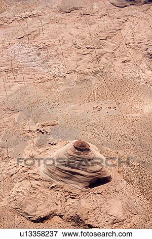 Stock Photo - Aerial of extruding rock formation in desert landscape of Utah, USA. Fotosearch