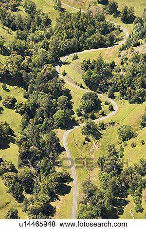 Aerial of road curving through rural landscape View Large Photo Image Stock Photo - Aerial of road curving through rural landscape. Fotosearch