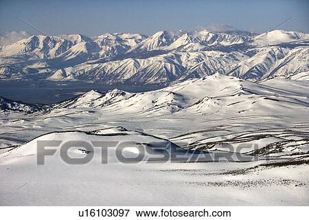 Aerial of snow covered mountain range in California View Large Photo Image Stock Photo - Aerial of snow covered mountain range in California. Fotosearch