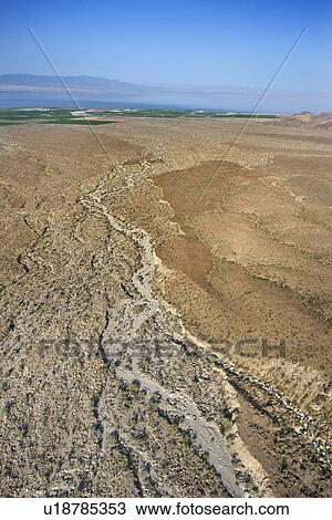 Aerial view of desert with lake and mountains in background. View Large Photo Image Stock Image - Aerial view of desert with lake and mountains in background.. Fotosearch