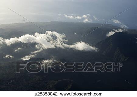 Aerial view of mountain landscape with clouds in Maui, Hawaii. View Large Photo Image Stock Image - Aerial view of mountain landscape with clouds in Maui, Hawaii.. Fotosearch