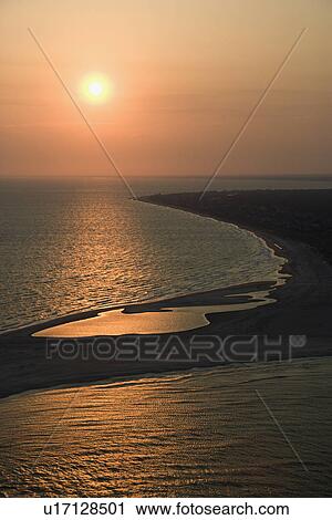 Aerial view of sun over Atlantic ocean and shoreline of Bald Head Island, North Carolina. View Large Photo Image Stock Image - Aerial view of sun over Atlantic ocean and shoreline of Bald Head Island, North Carolina.. Fotosearch