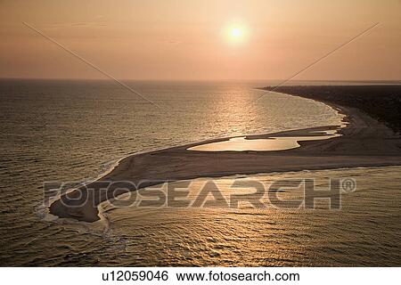 Aerial view of sun over Atlantic ocean and shoreline of Bald Head Island, North Carolina View Large Photo Image Stock Photograph - Aerial view of sun over Atlantic ocean and shoreline of Bald Head Island, North Carolina. Fotosearch