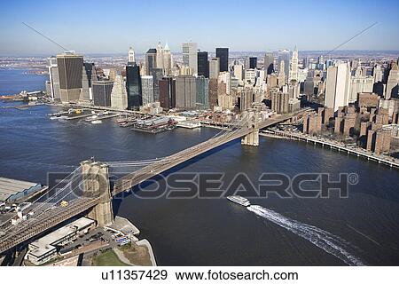 Aerial view of in New York City with Brooklyn Bridge and Manhattan skyline with ferry boat View Large Photo Image Stock Photo - Aerial view of in New York City with Brooklyn Bridge and Manhattan skyline with ferry boat. Fotosearch