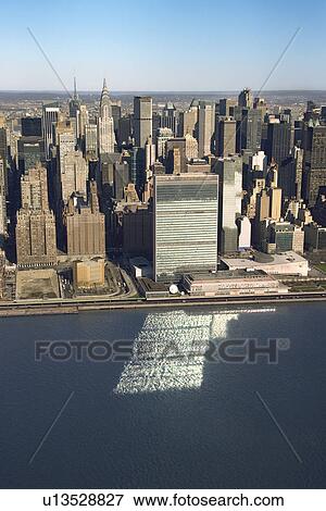 Aerial view of Midtown Manhattan, New York with United Nations Headquarters building reflecting in East River View Large Photo Image Stock Photo - Aerial view of Midtown Manhattan, New York with United Nations Headquarters building reflecting in East River. Fotosearch