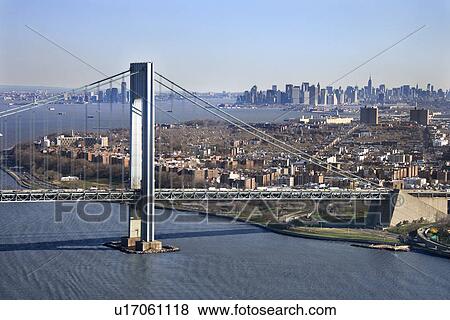 Stock Photo - Aerial view of New York City's Verrazano-Narrow's bridge with Manhattan skyline.. Fotosearch