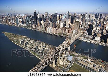 Aerial view of Queensboro Bridge in New York City with Roosevelt Island and Manhattan cityscape View Large Photo Image Picture - Aerial view of Queensboro Bridge in New York City with Roosevelt Island and Manhattan cityscape. Fotosearch