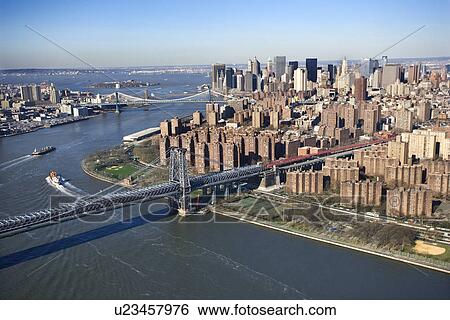 Stock Photograph - Aerial view of Williamsburg Bridge with Manhattan and Brooklyn bridges in background and view of lower east Manhattan. Fotosearch