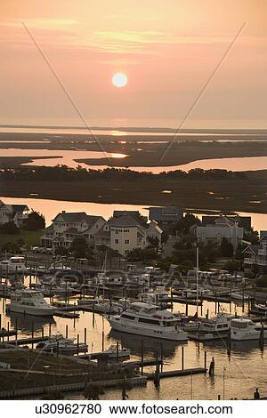 Stock Image - Aerial view of coastal village with marina on Bald Head Island, North Carolina. Fotosearch