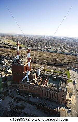 Aerial view of factory with smokestacks and city in distance View Large Photo Image Stock Image - Aerial view of factory with smokestacks and city in distance. Fotosearch